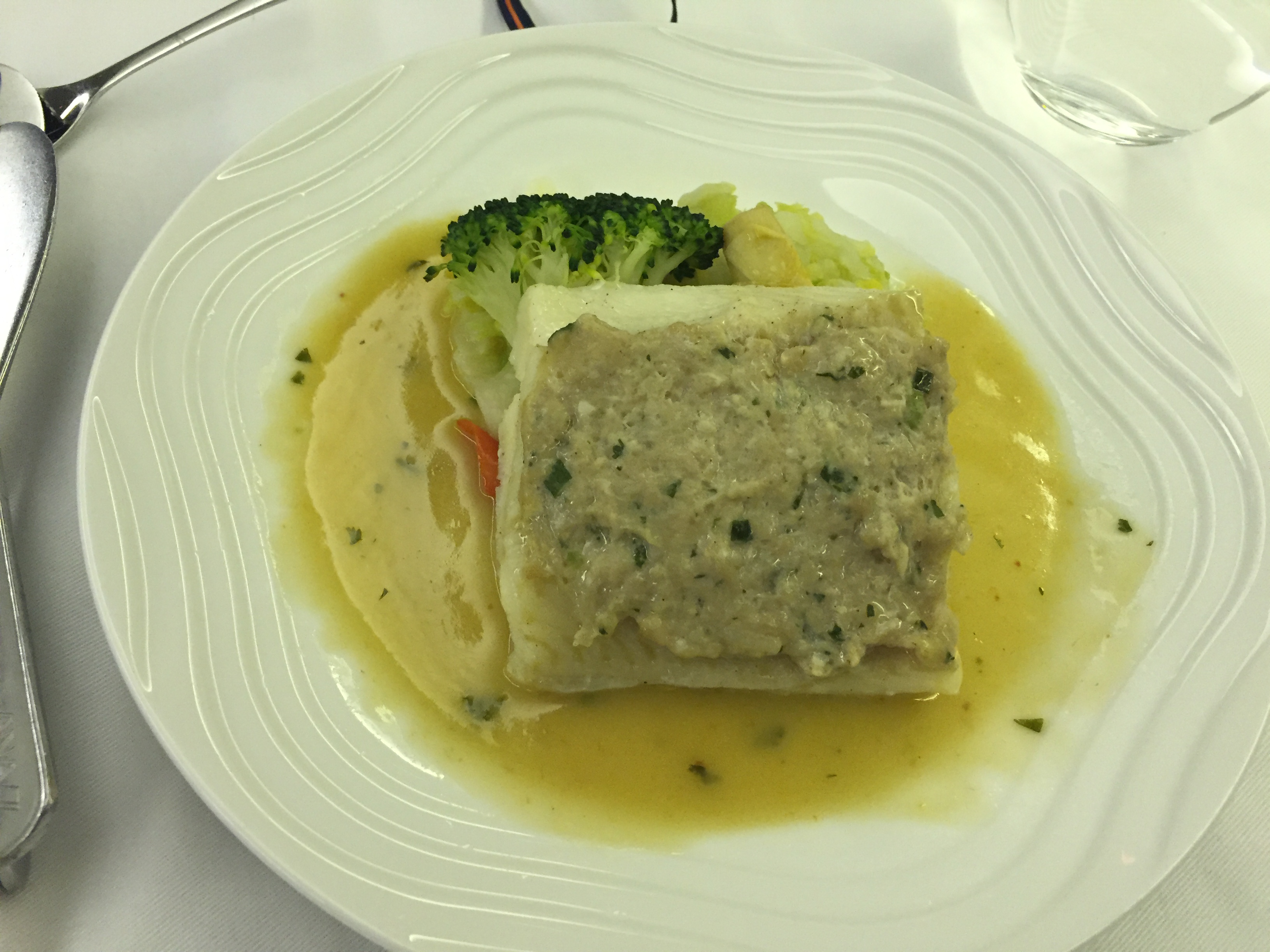 Fish fillet with herb butter sauce, broccoli, and pasta