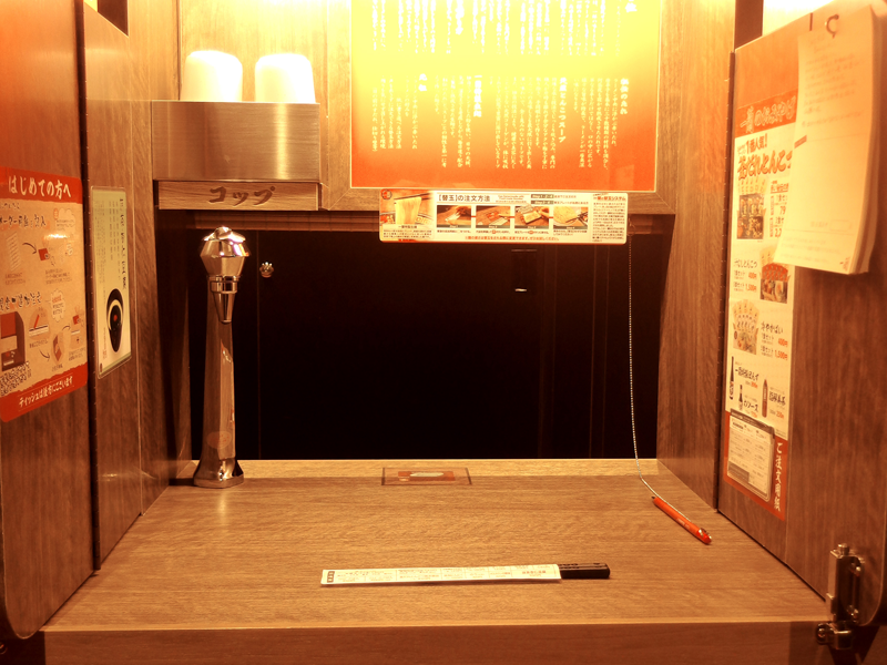 Single booth with bamboo curtain and counter