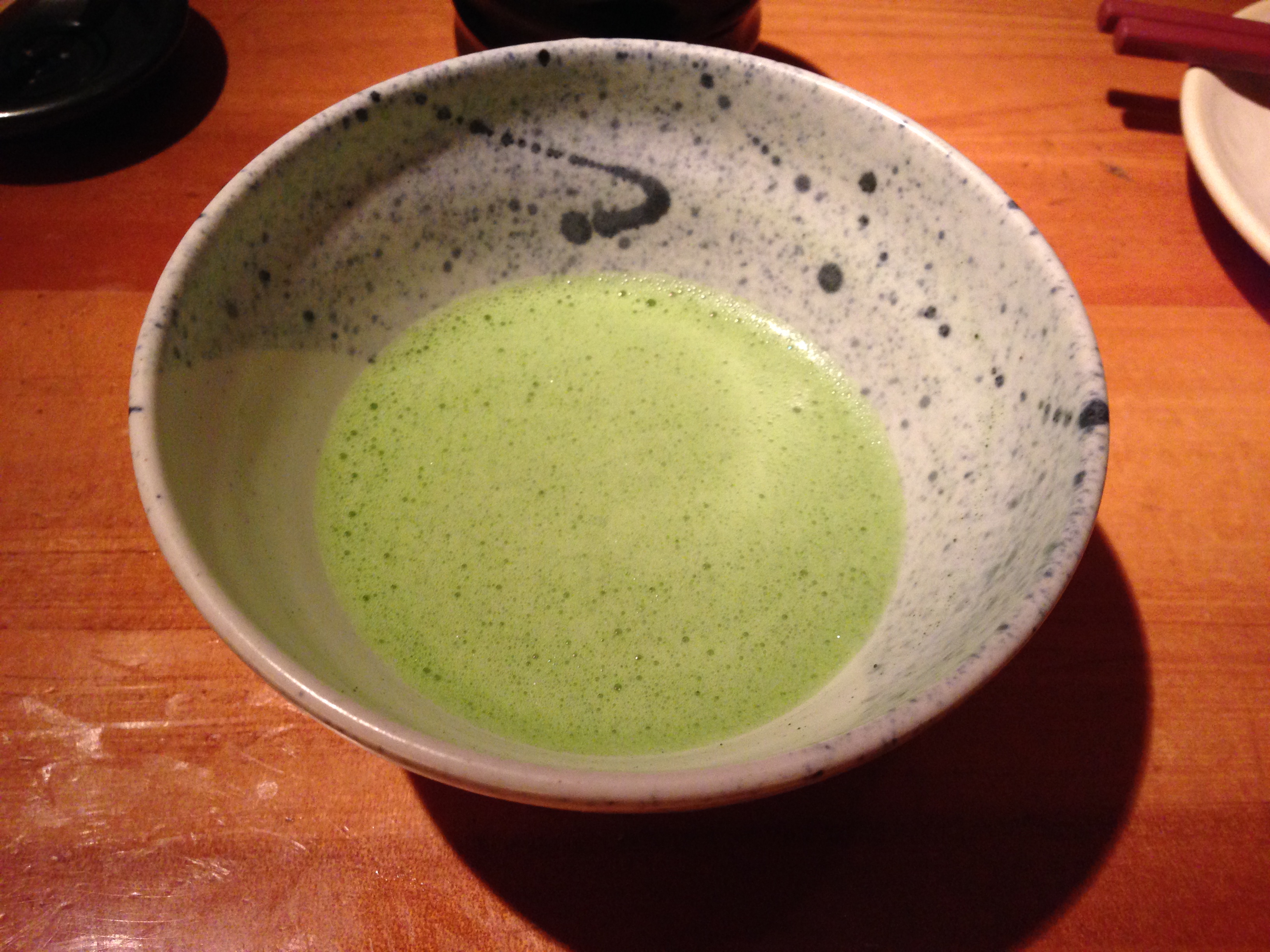 A bowl of frothy matcha green tea
