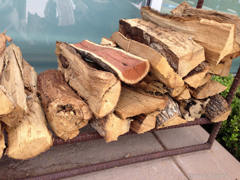Stacked firewood outside the restaurant for the wood-fired oven