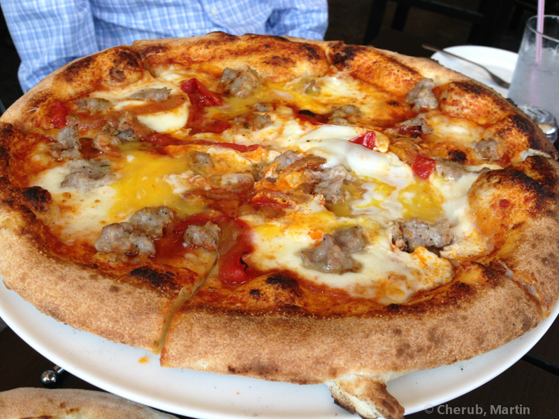 Sweet sausage pizza with tomato sauce and melted mozzarella