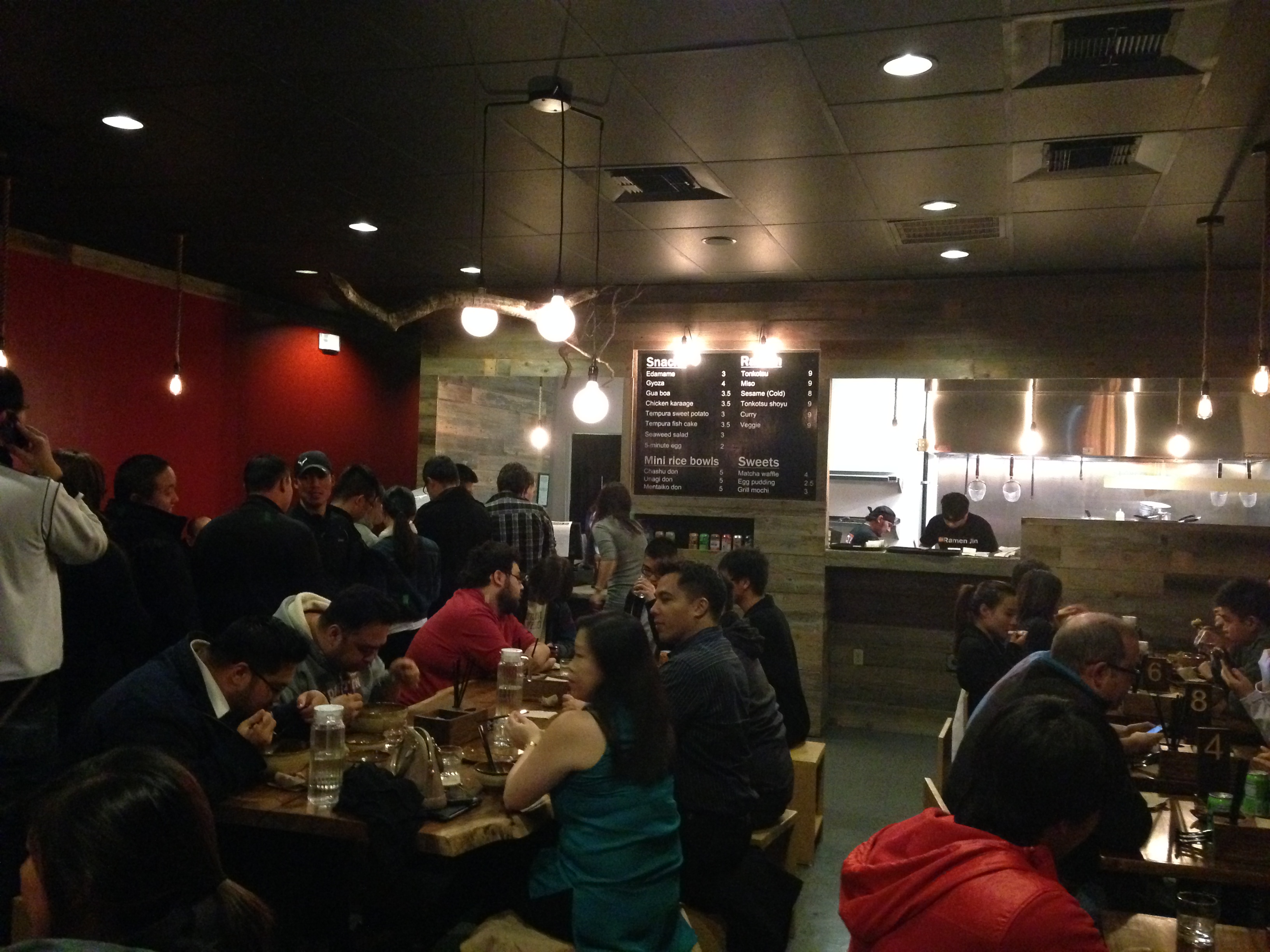 Packed interior — every table full, people standing, the line barely moving