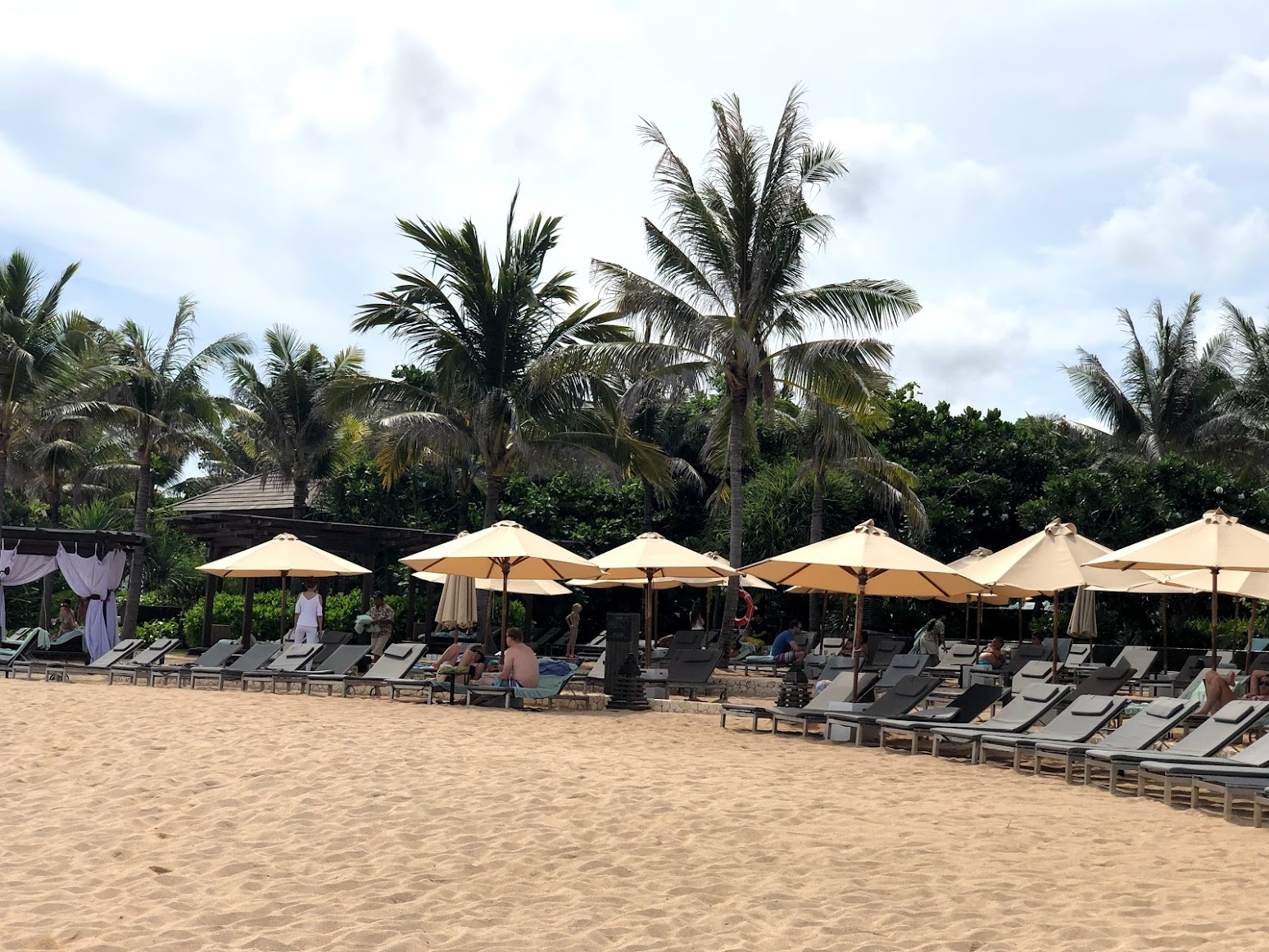 Private beach with lounge chairs and umbrellas